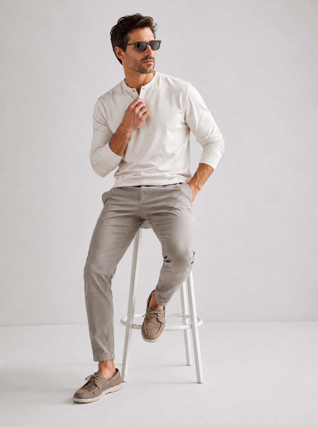 Man wearing Hudson Bros. white long sleeve coastal performance shirt, light tailored pants, and boat shoes.
