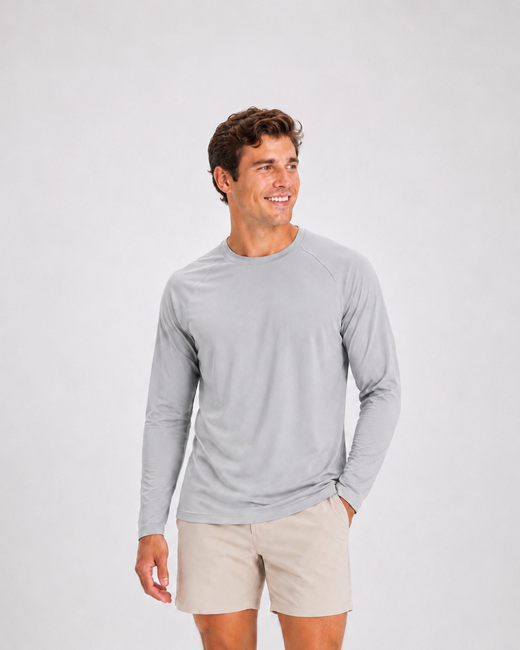 Male model wearing the Hudson Bros. Everyday Shade Long Sleeve UPF 50 sun shirt in Mist gray with khaki shorts.